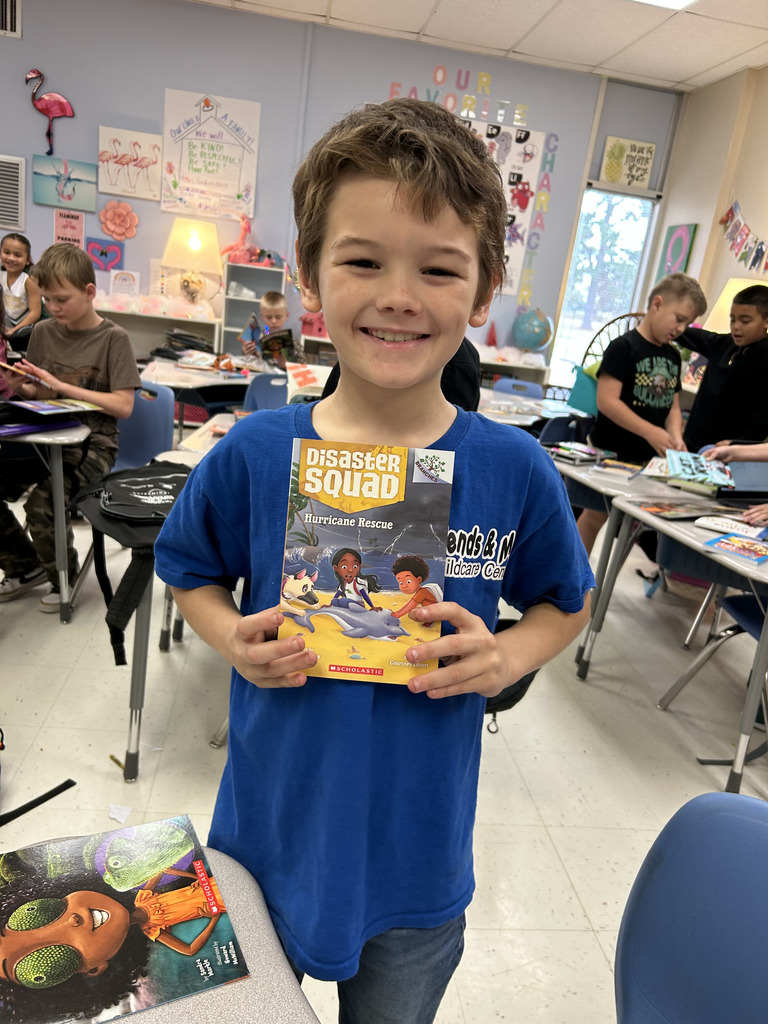 student holding book