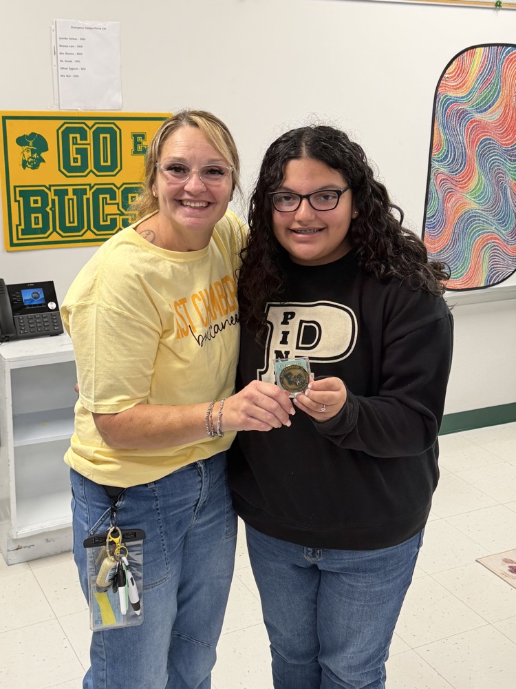Emma receiving Buccaneers challenge coin