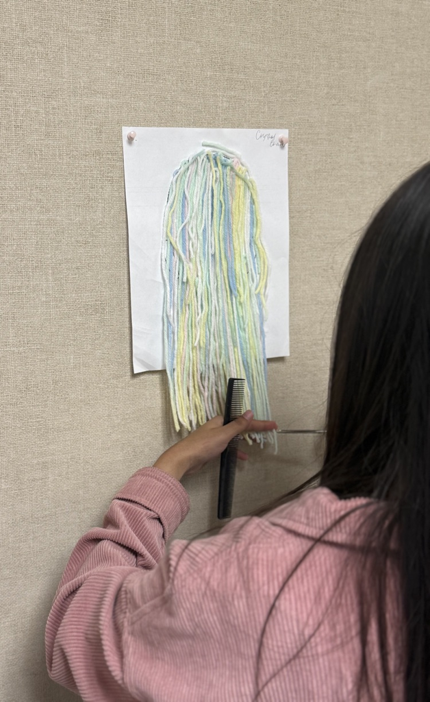 Cosmetology student learning to cut hair