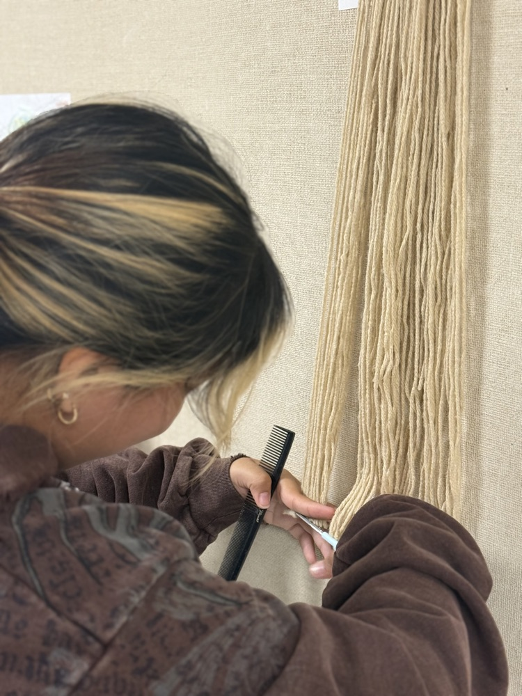 Cosmetology student learning to cut hair