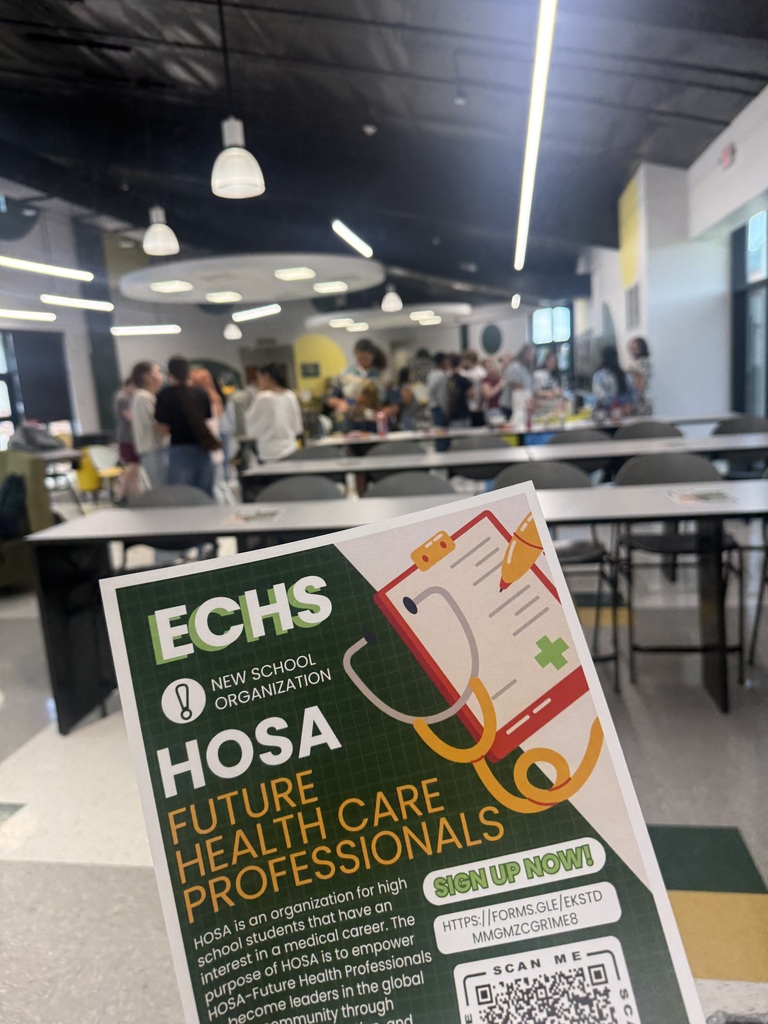 A room filled with tables and chairs, people standing, a sign that reads "Echs Hosa Future Health Care Professionals".