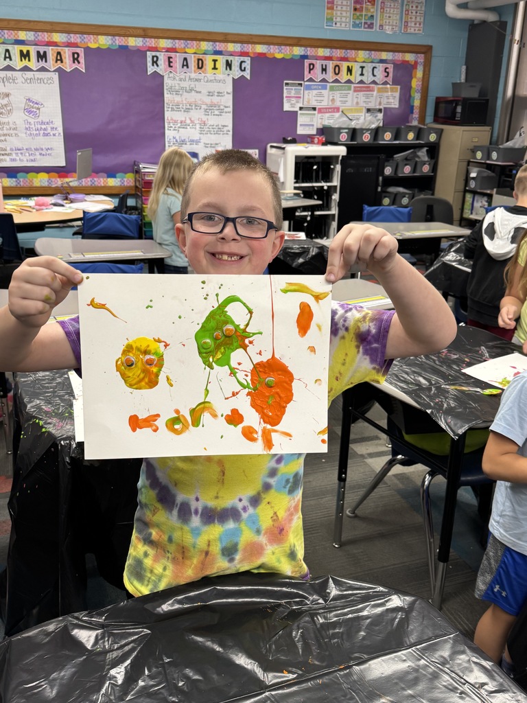Second grader showing off his finished product