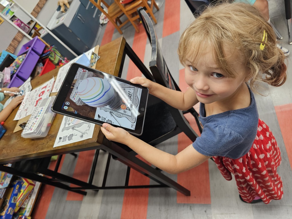 Student showing off her rainbow striped dot