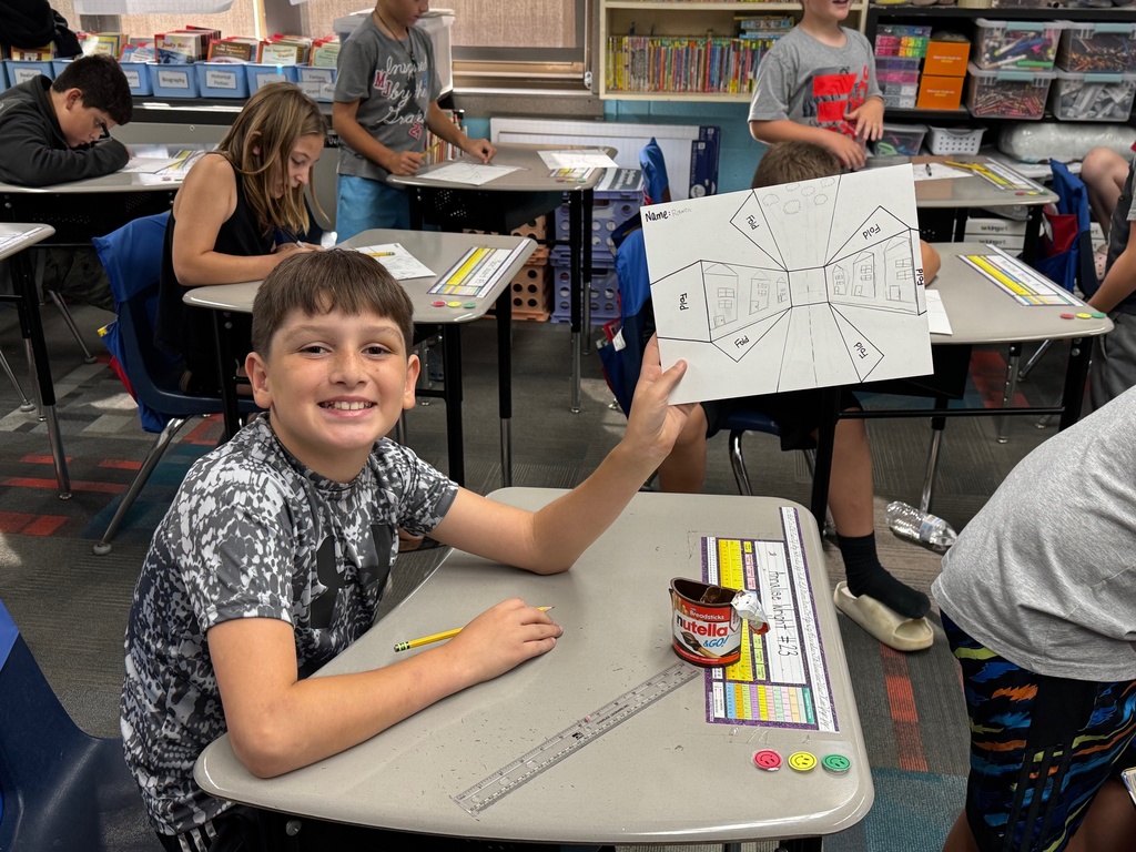 Student showing off his artwork