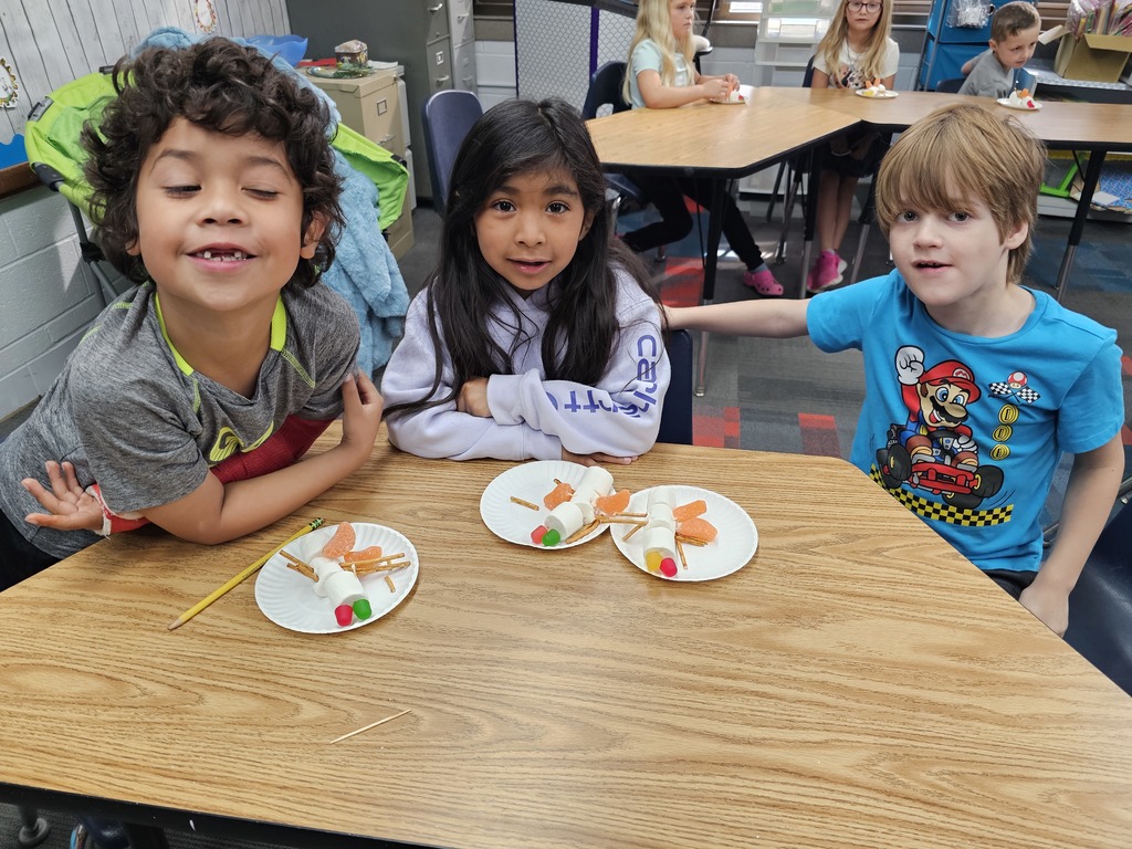 Three students with their insects