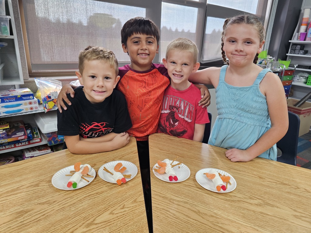 Four students with their insects