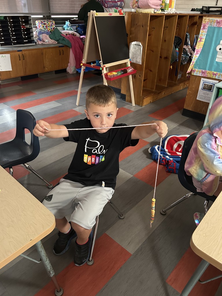 Student showing off his rainbow cereal
