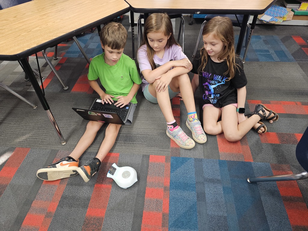 3 students seeing if the Finchbot follows directions