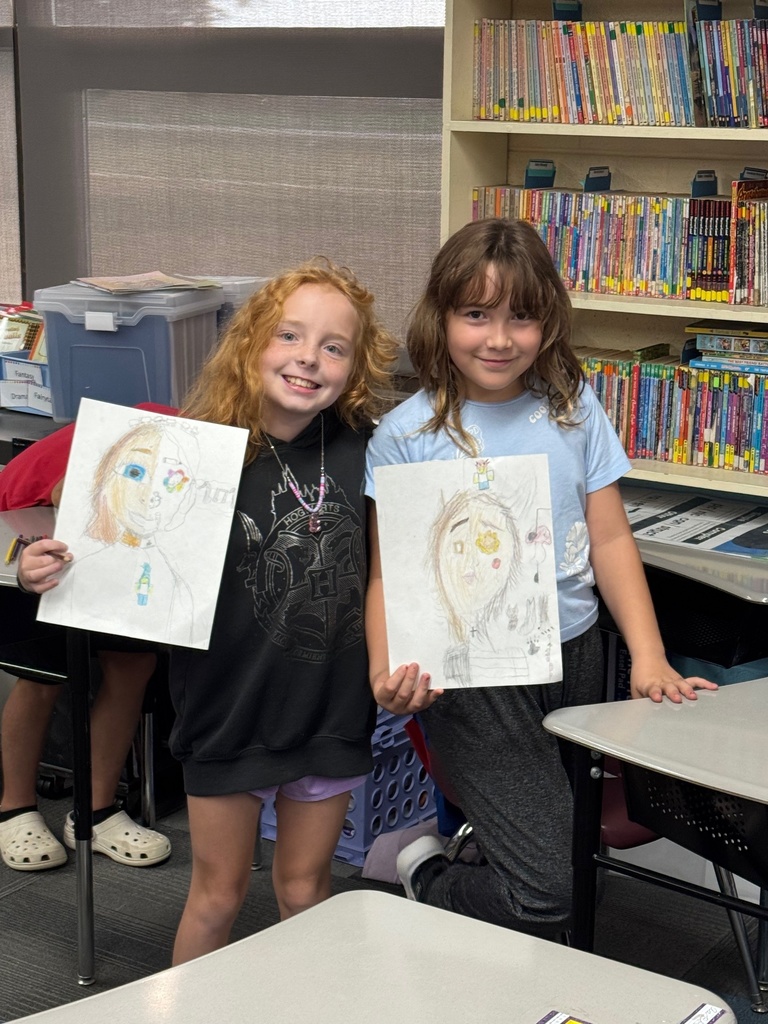 Two girls showing off their finished products