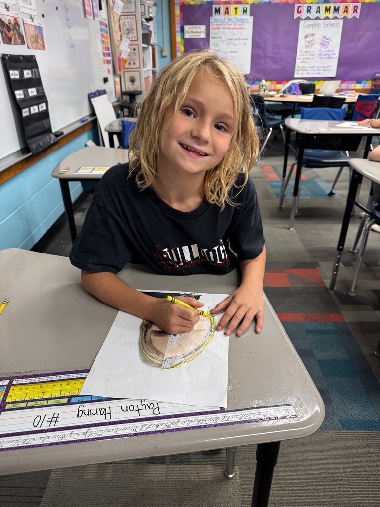 1st Grader working on her self portrait