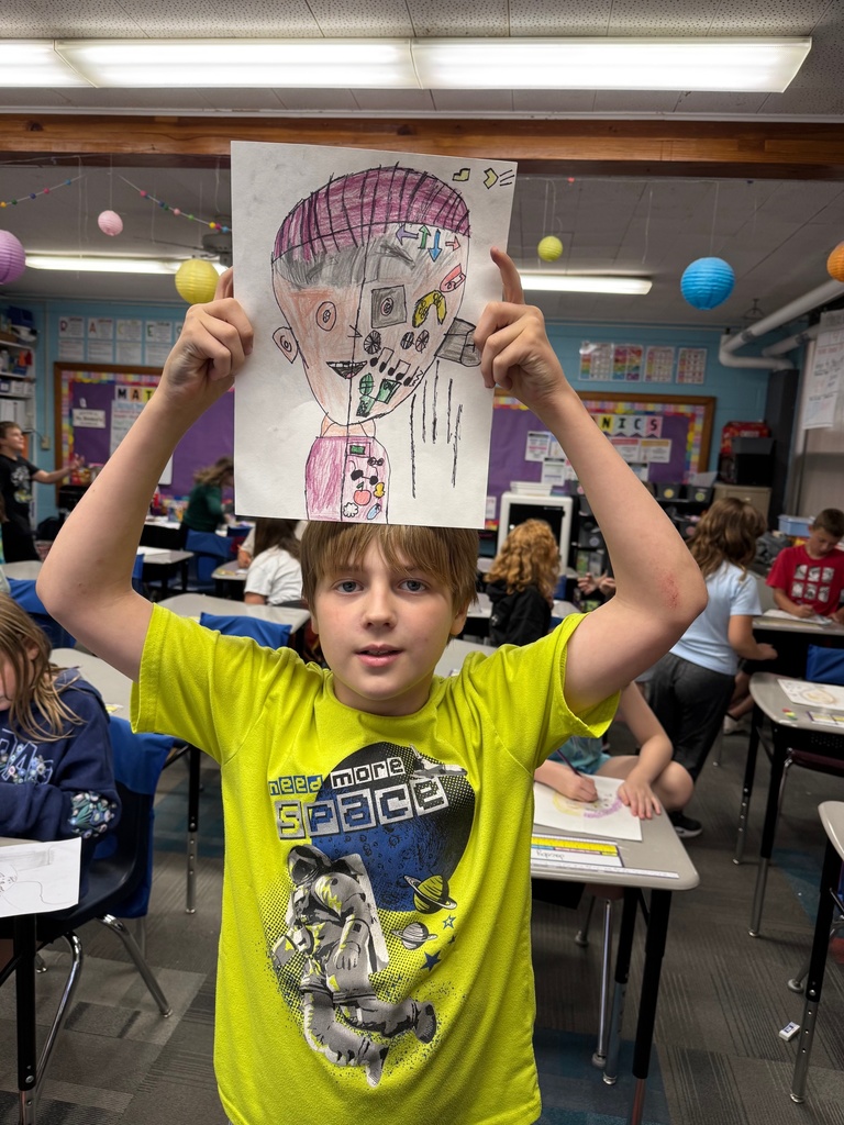 Fourth grader showing off his self portrait