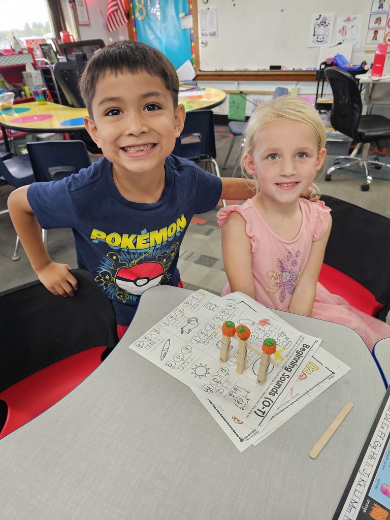 Two students showing off their 3 pumpkin gate