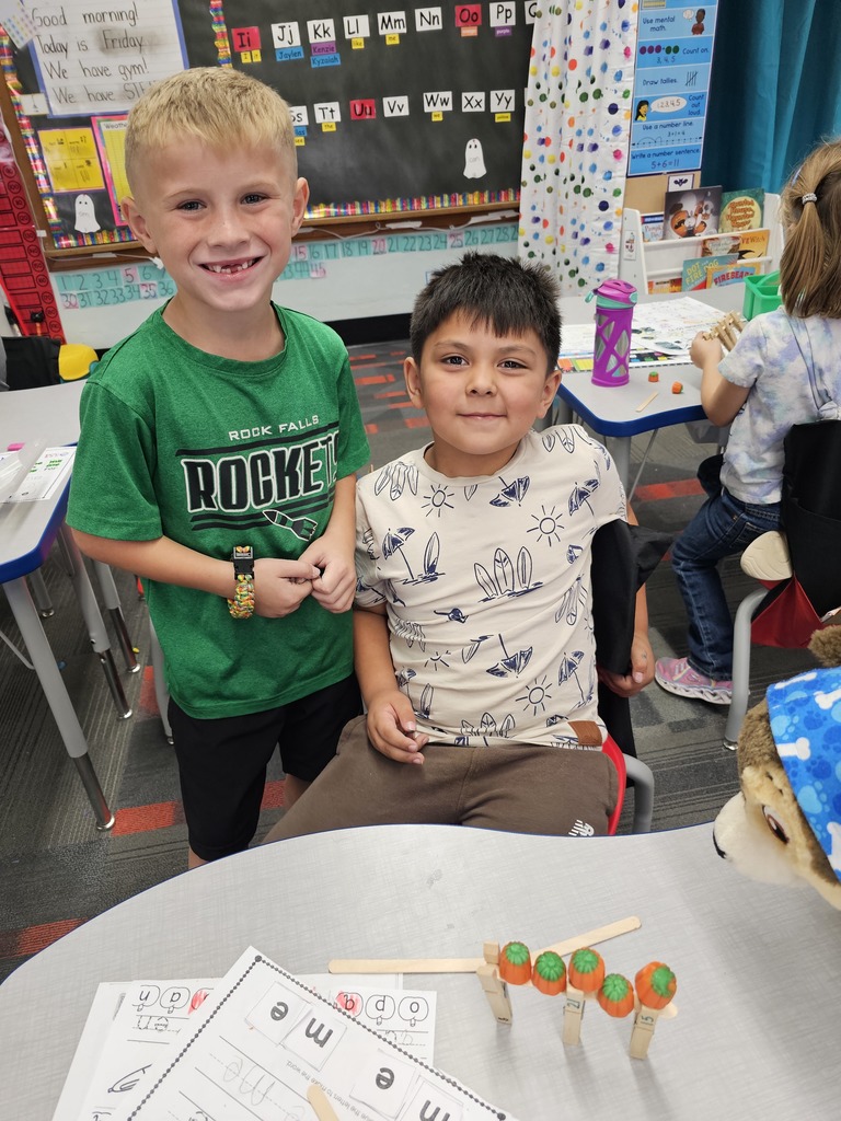 Two boys showing off their pumpkin gate. no hands!