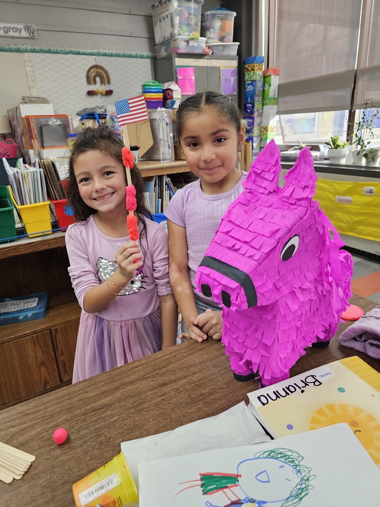 Two girls waving their flag