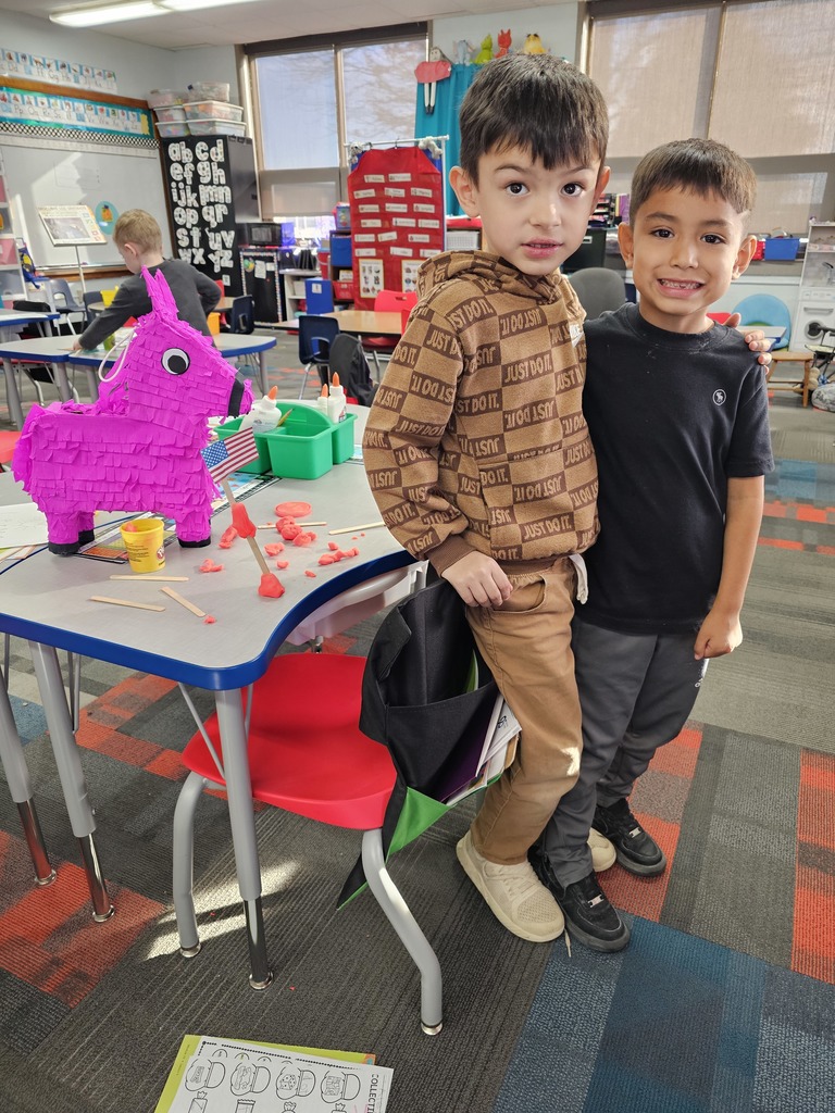 Two boys showing off their flag