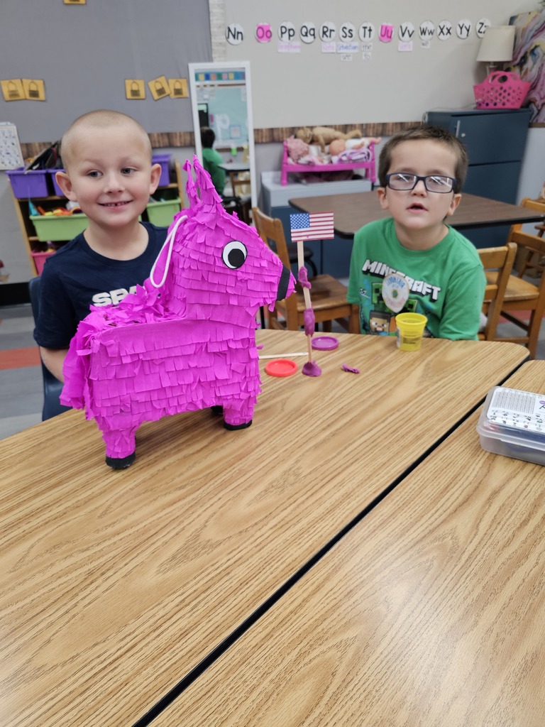 Two boys showing off their flag