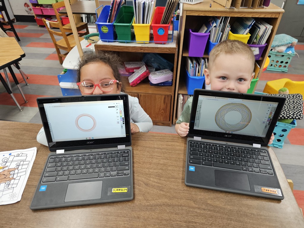 Two kindergarten kids showing off their spirographs
