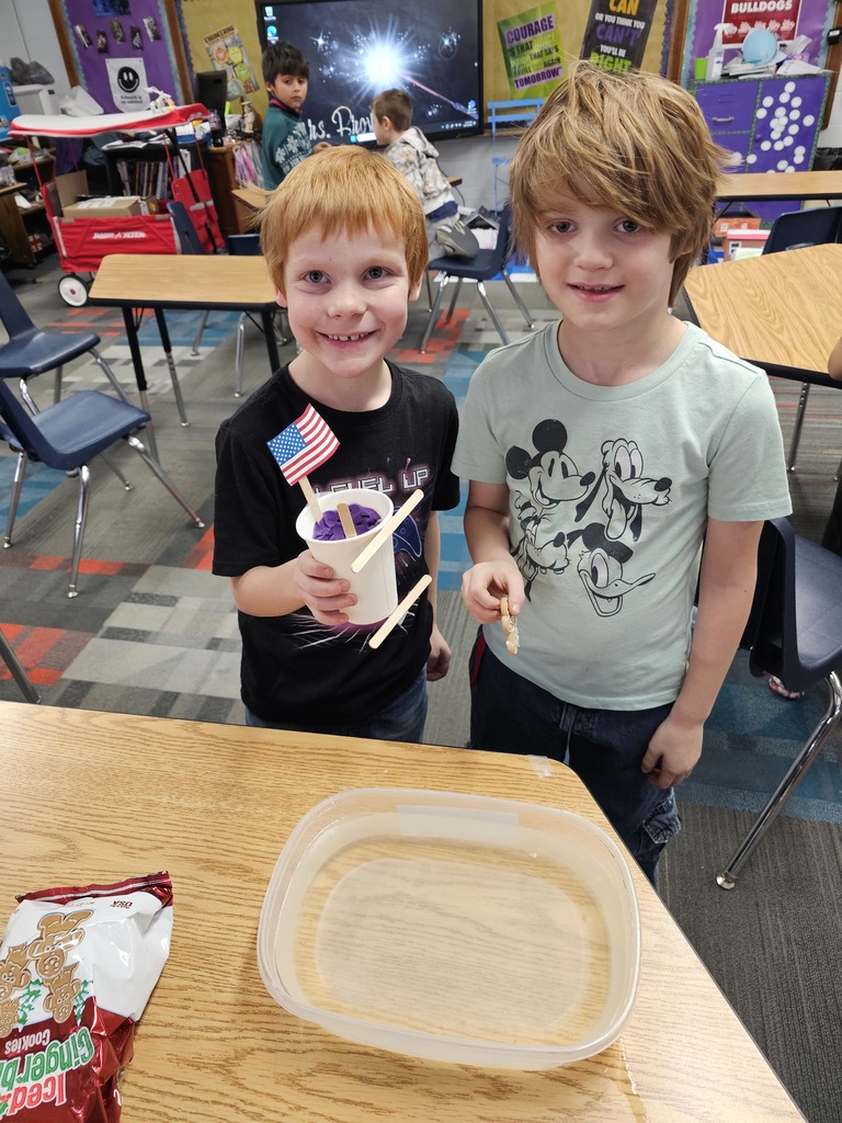 Two boys showing off their creation