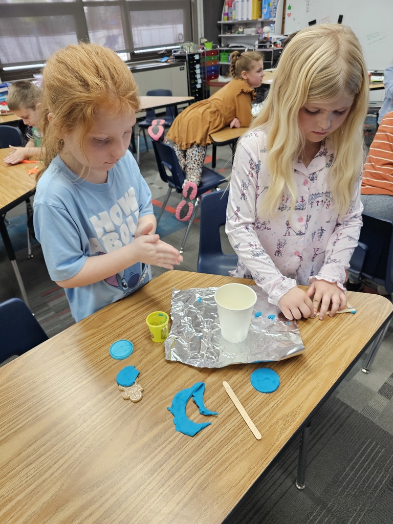 Two girls building their boat