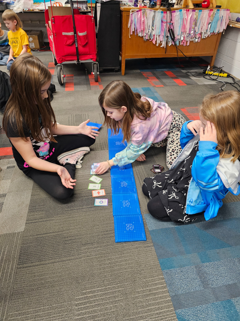 Three girls coding their robot