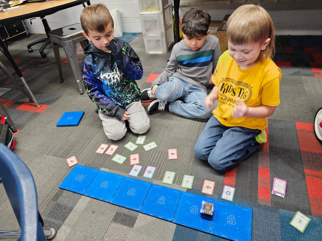 Three boys watching their KaiBot