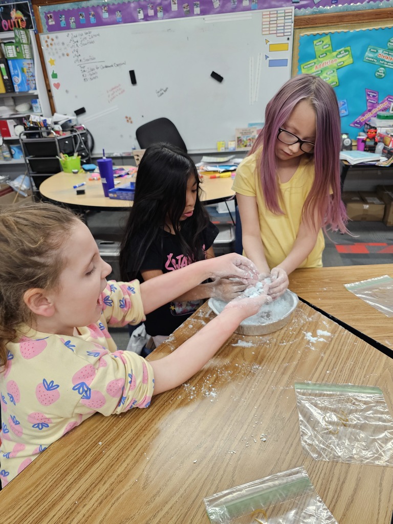 Three girls making snow