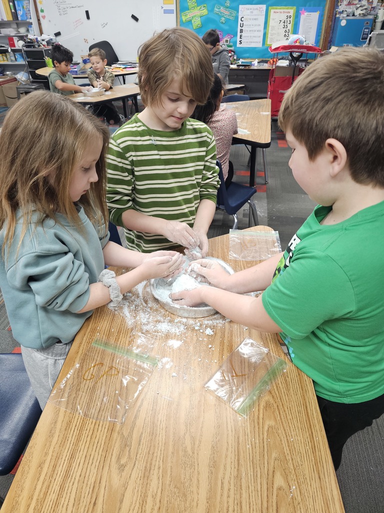 Three students making snow