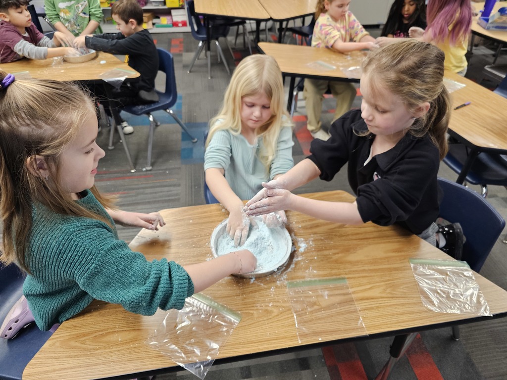 Three girls making snow