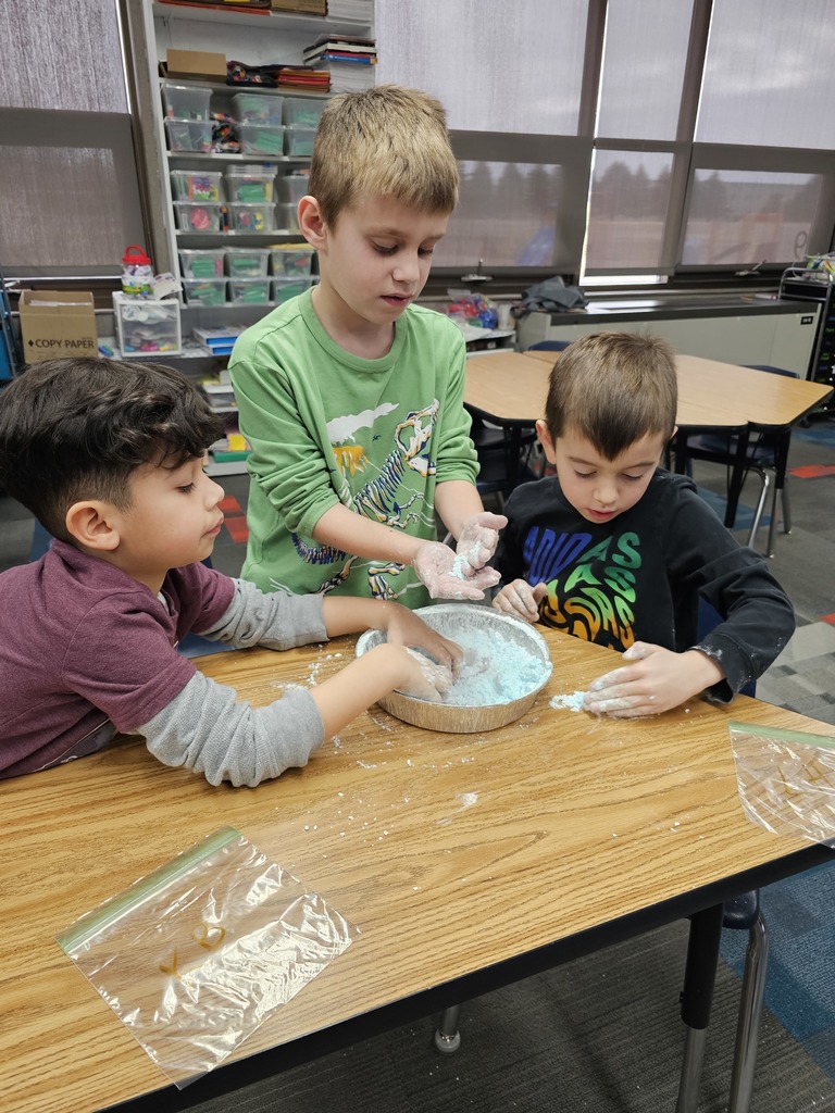 Three boys making snow