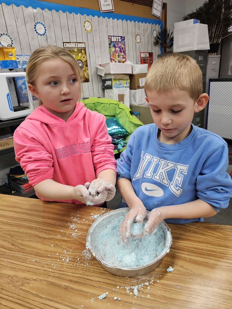 Two students making snow