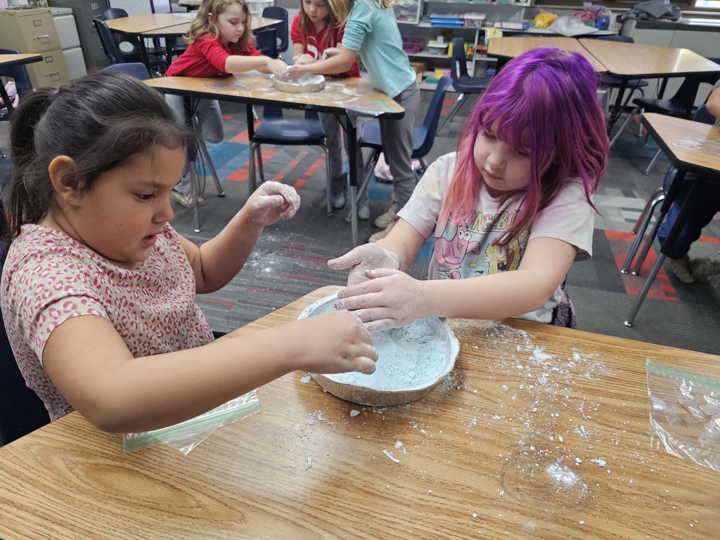 Two students making snow