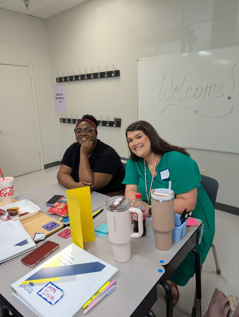 Two new educators smiling.