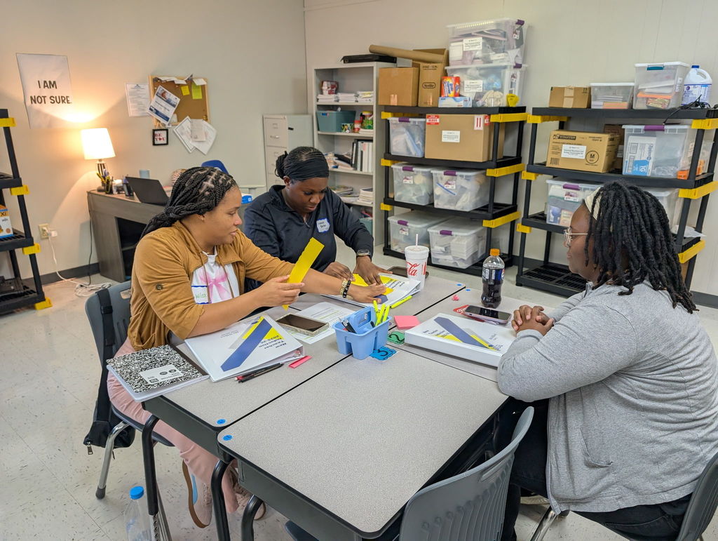 Three new educators collaborating.