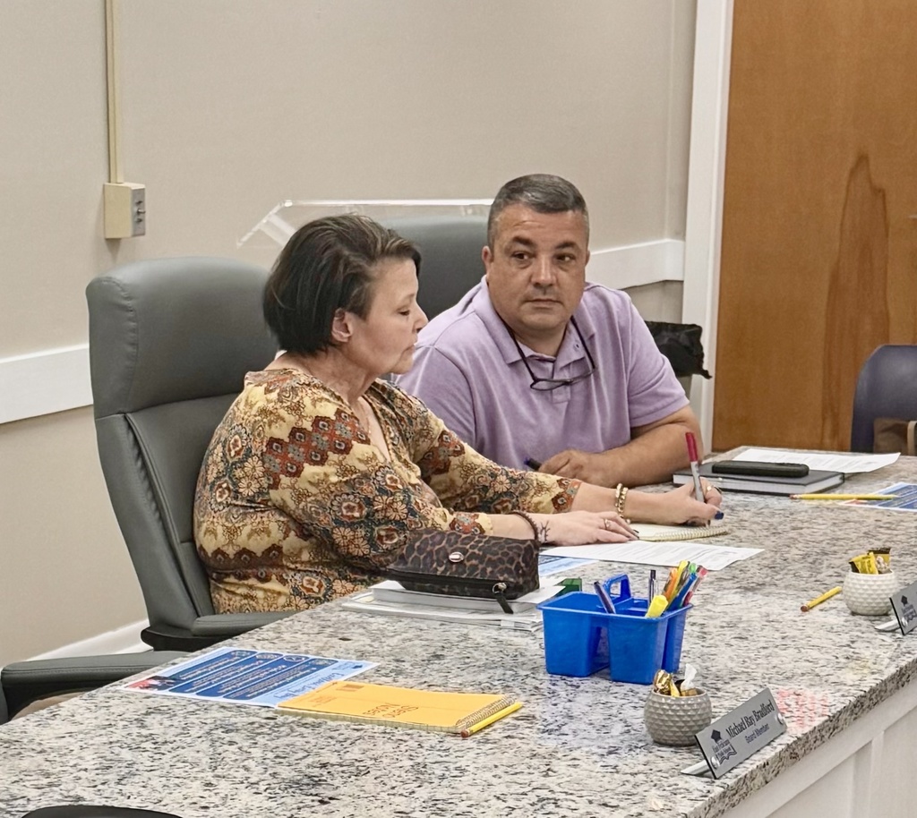 Two board members collaborate.