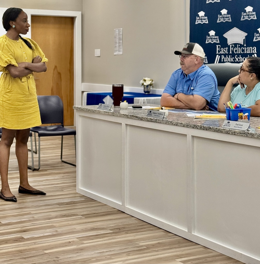 Two board members confer with a facilitator.