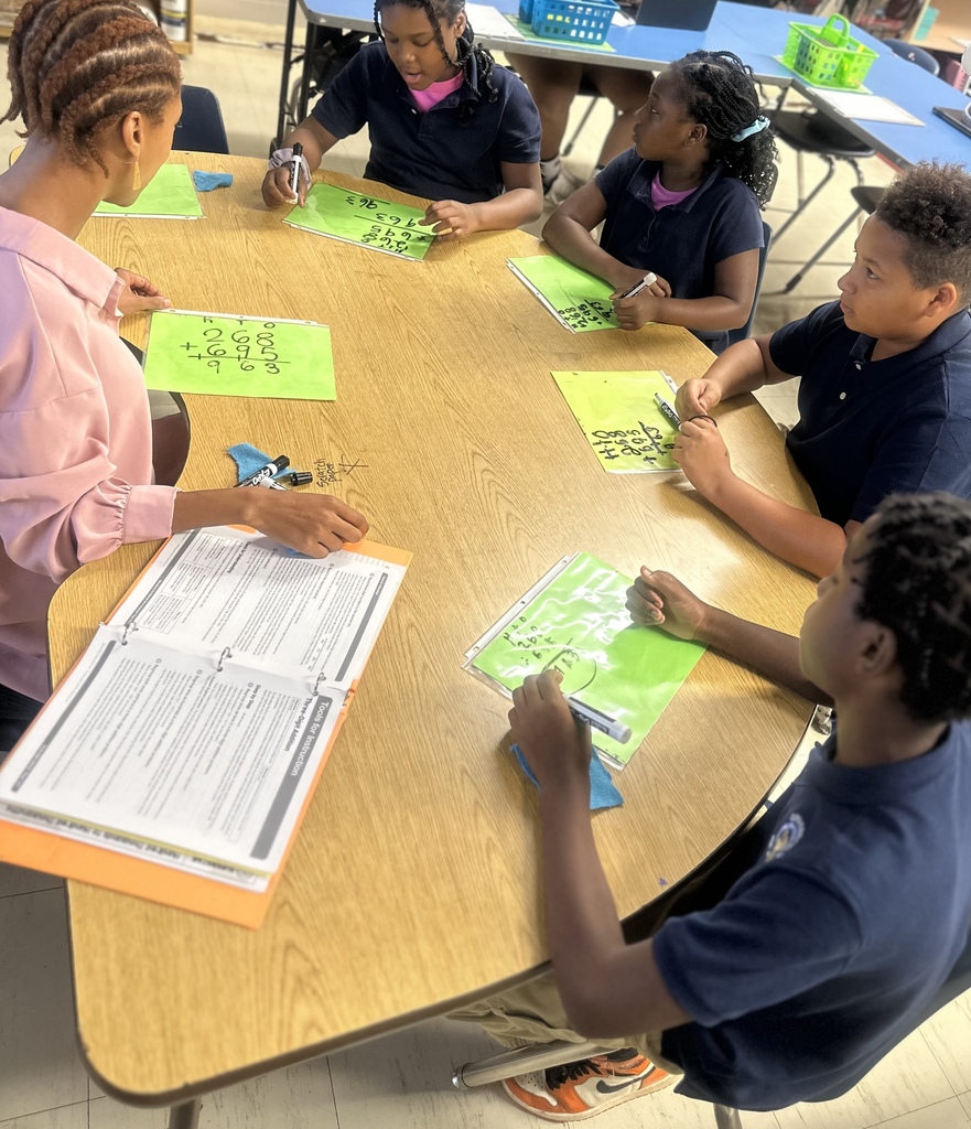 A teacher works with a small group of students.