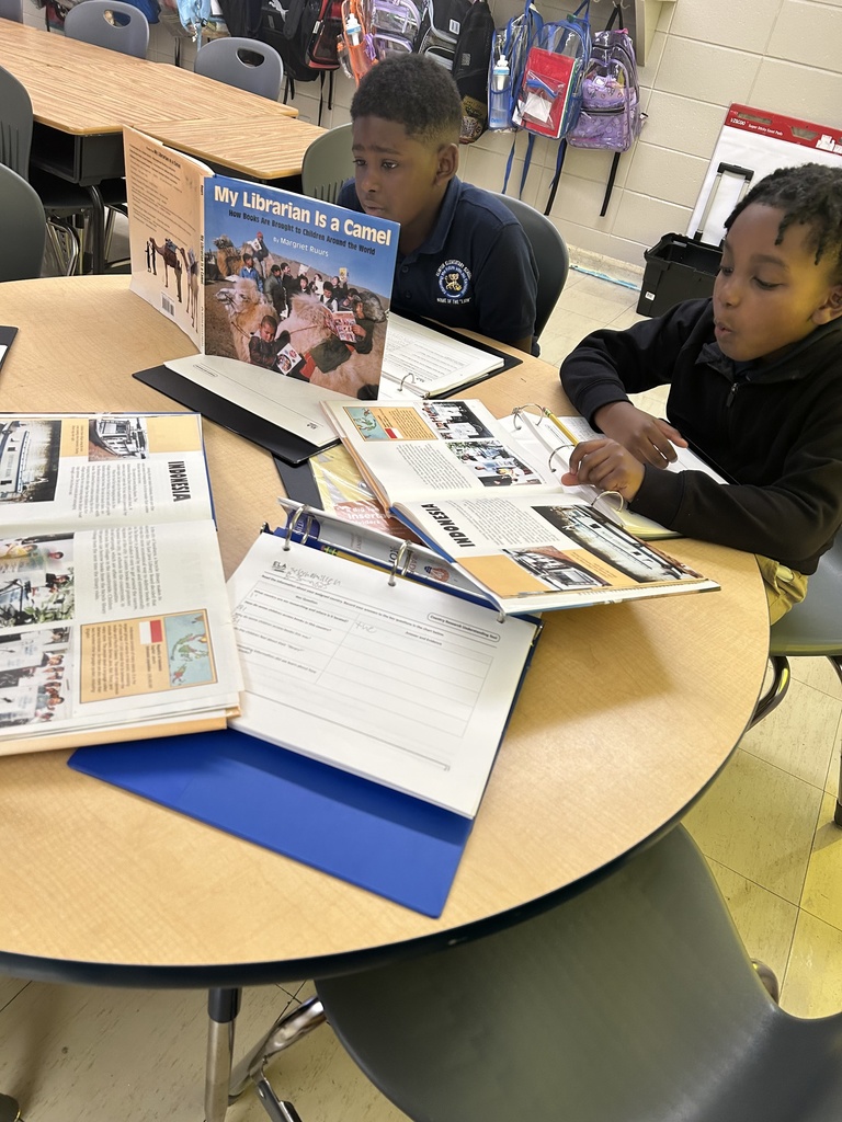 Students reading a book called My Librarian is a Camel.