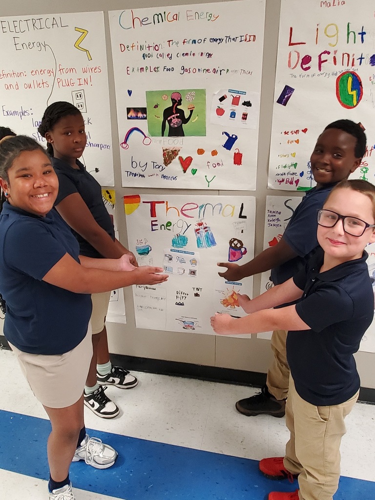Students highlighting a poster they designed.