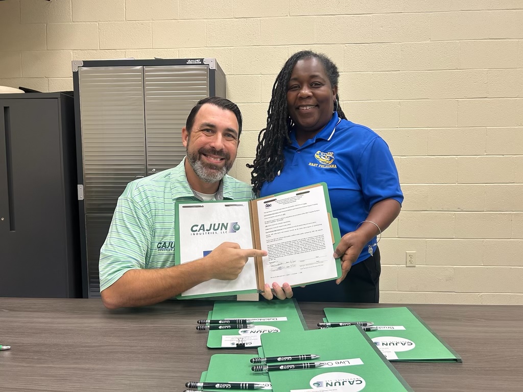 Two people holding a contract.