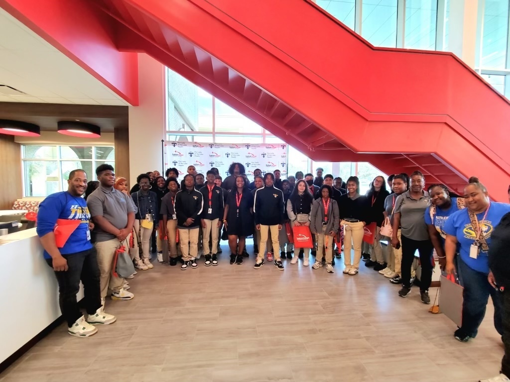 Students and teachers in a college lobby.