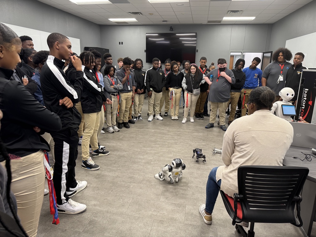 Students observing a robot in action.