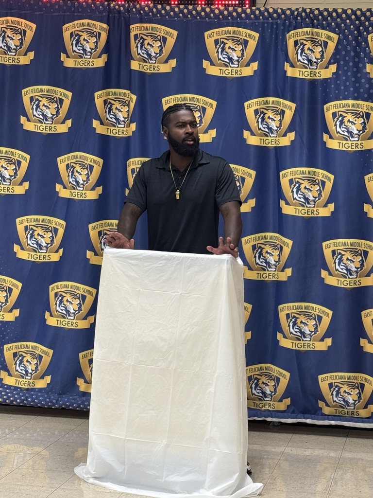 Teacher speaking at a podium.