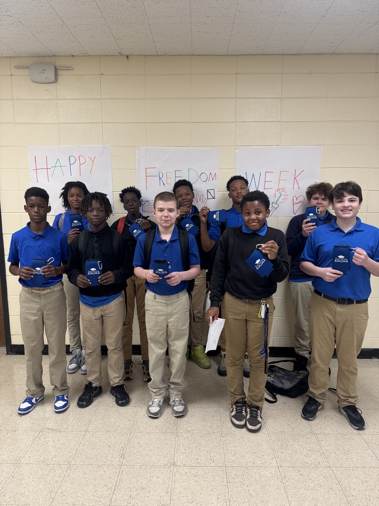 Studnets smiling in uniform.