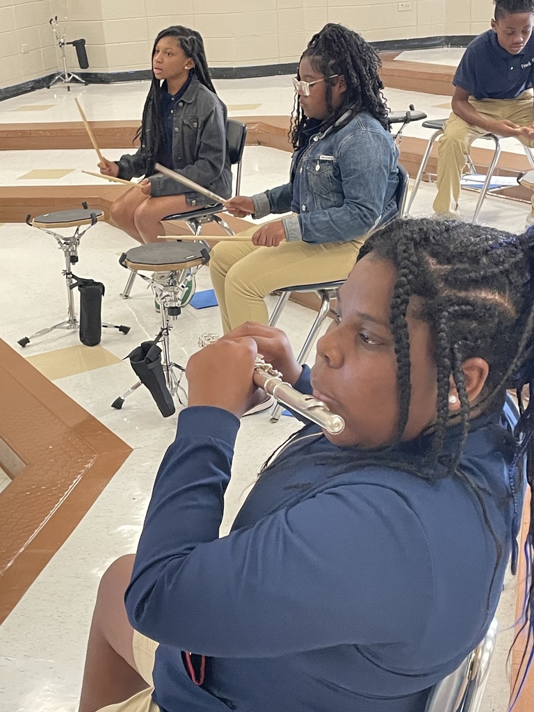 Students playing flutes and drums.