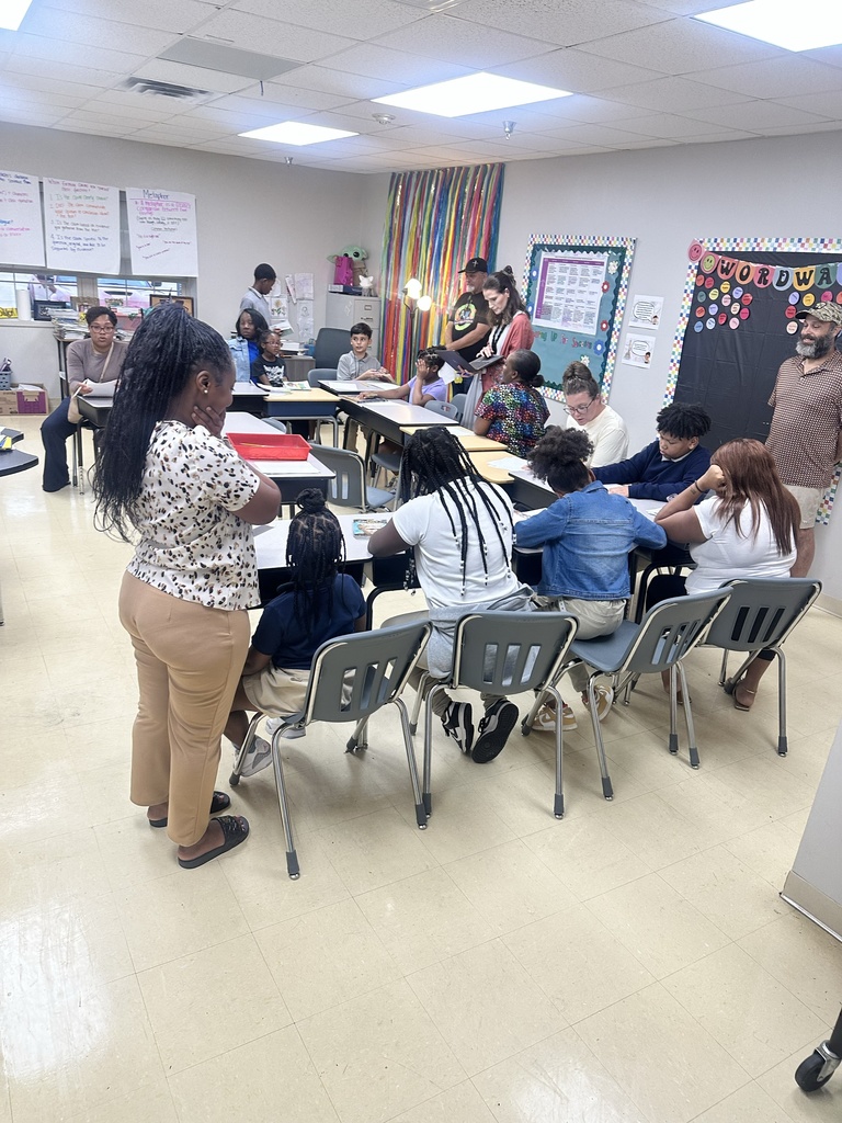 A group of families gather in a classroom.