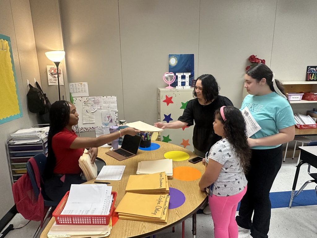 A teacher and a family are talking.