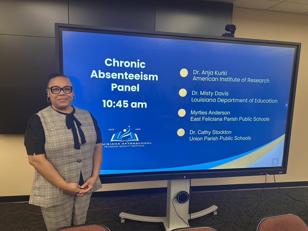 An educator in front of a display
