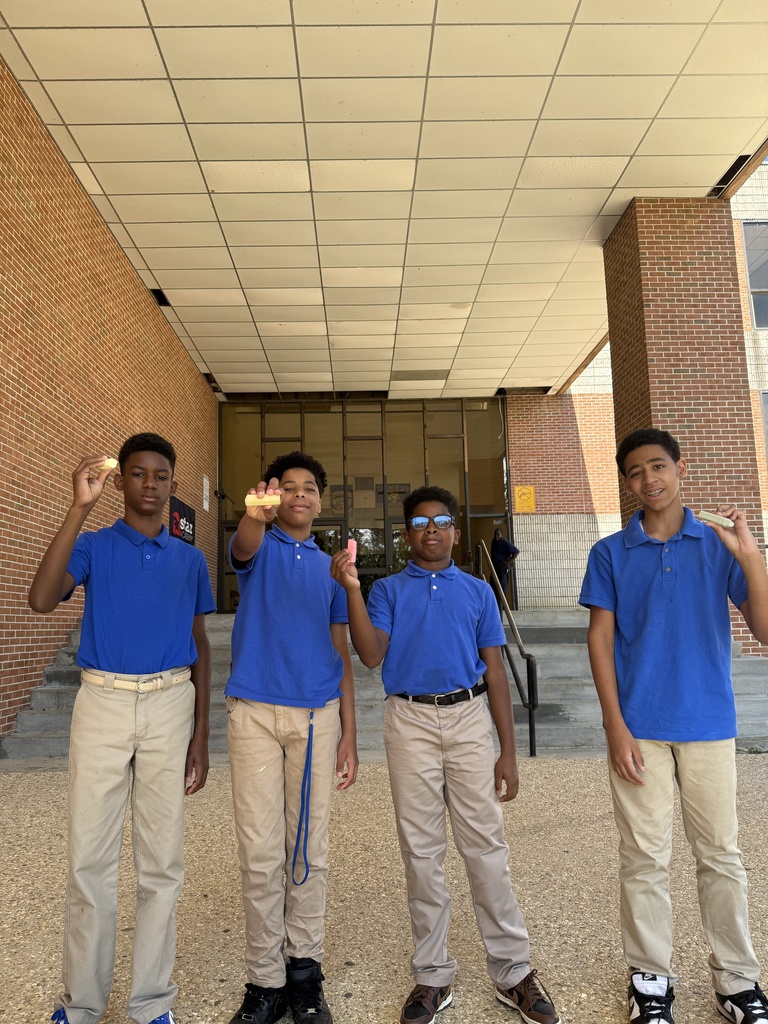 Students holding up chalk.