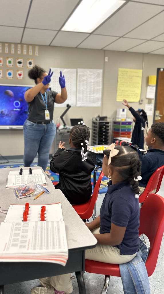 A teacher demonstrates five and some more to eager students.