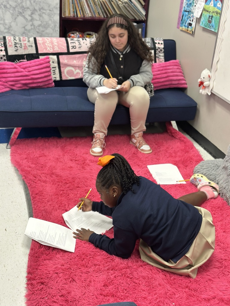 A high school student tutors an elementary student.